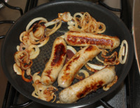 Sausages and onion rings fried.